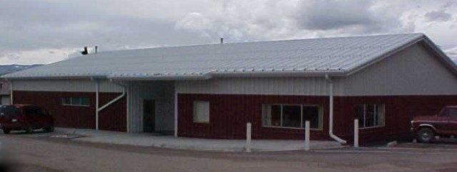 Drummond Library Building with 2 vehicles parked